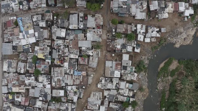 4K aerial view of slums or squatter camp along the Jukskei river in the Alexandra township, South Africa 