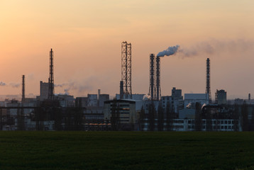 Factory pipe polluting air against sunset, environmental problems, smoke from chimneys