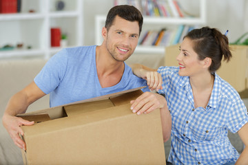 happy adult couple moving out or in to new home