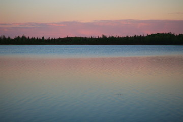 A beautiful sunset on the lake, summer midnight in Alaska