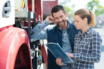 female supervisor next to lorry driver