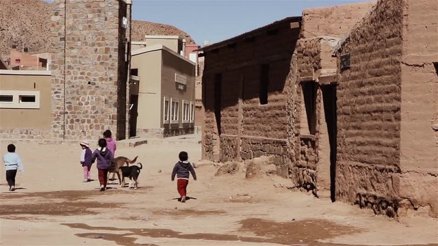 Children Walking on a Dirt Street near Adobe Houses in the Andean Village of Susques, Jujuy Province, Argentina. 