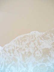 Sea water wave and water foam on beach background