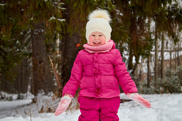 Cute small girl in the winter forest