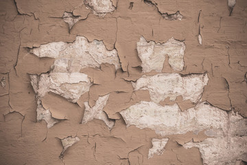 Cracked light brown wall texture background. Grunge textured wall background. Brown retro rough texture. Cracked peeling beige paint on concrete wall. Old light brown concrete texture. 