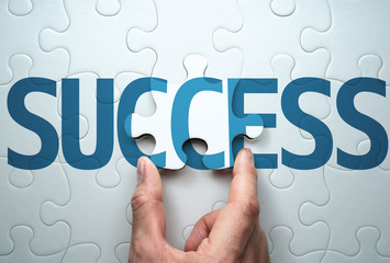 Succeed in solving problem. Concept image of success.Connecting last jigsaw puzzle piece.