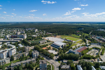 Top down aerial drone image of a Ekaterinburg with stadiums: ready and under construction. Midst of summer, backyard turf grass and trees lush green.