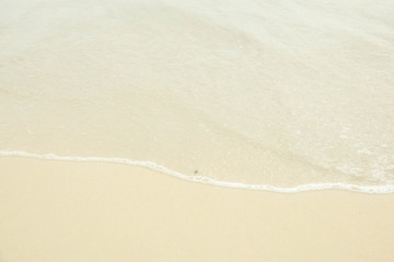 Sea water wave and water foam on beach background