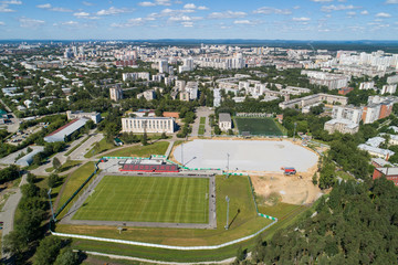 Top down aerial drone image of a Ekaterinburg with stadiums: ready and under construction. Midst of summer, backyard turf grass and trees lush green.