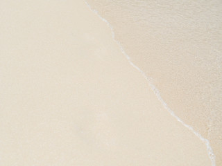 Fototapeta na wymiar Sea water wave and water foam on beach background