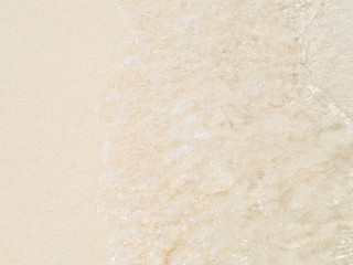 Sea water wave and water foam on beach background
