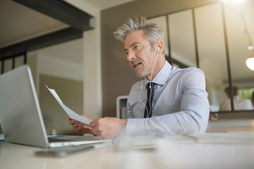 Businessman on video call in contemporary office