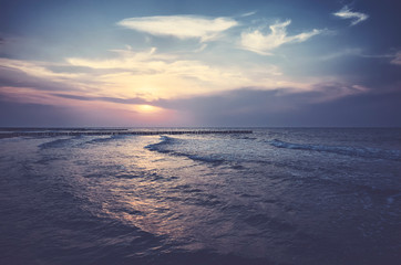 Fototapeta na wymiar Scenic sunset over the sea, color toned picture.