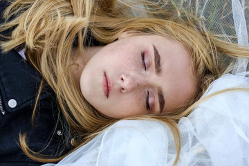 Portrait of a beautiful white blonde girl with freckles on her face