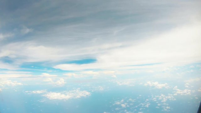 POV flying bird fantastical pattern of white clouds in blue sky under ocean