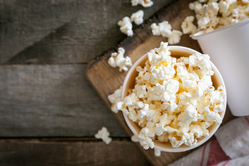 Home made pop corn in white cups on wood background