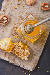 Honey background. Sweet honey in the comb, glass jar.