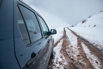 Fotobehang car on winter road © Daniel