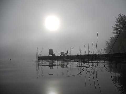 Silhouetted jetty in a misty morning
