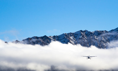 Sky diving plane with mountains