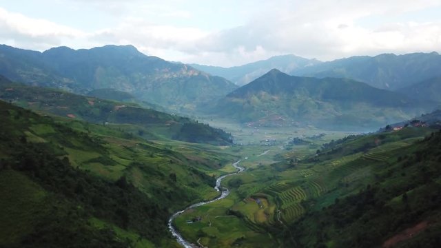 Breathtaking traditional landscape of Vietnam, river running through rice terraces into mountains