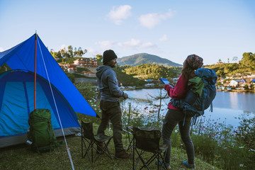 Asian couple Camp on the mountain in the upper village near the lake, Camping Travel Concept,Travel Relax concept Map.