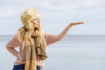 Fashionable woman on beach pointing