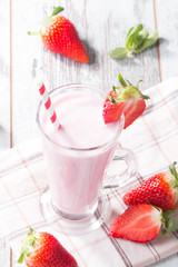 Fresh milk, strawberry on wooden table, assorted protein cocktail with fresh fruits. Natural background. 