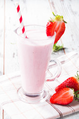 Fresh milk, strawberry on wooden table, assorted protein cocktail with fresh fruits. Natural background. 