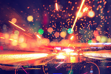 Obraz premium blur motion night car driving colorful high speed raining road.