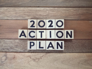 New Year Plan concept - 2020 Action Plan written on wooden blocks.