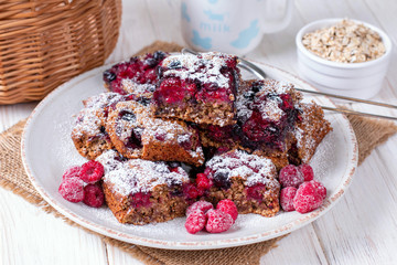Homemade oatmeal cake with berries and powdered sugar