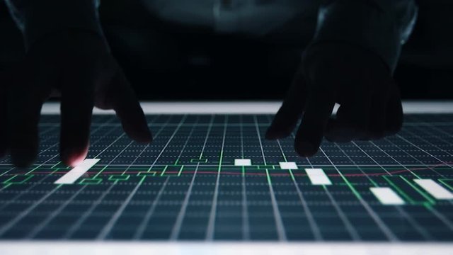 Man indicators on sensor touch screen sensory interactive table in the dark. 