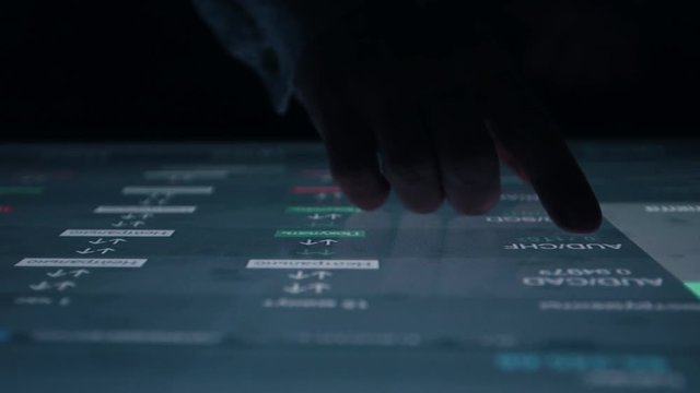 Man indicators on sensor touch screen sensory interactive table in the dark. 