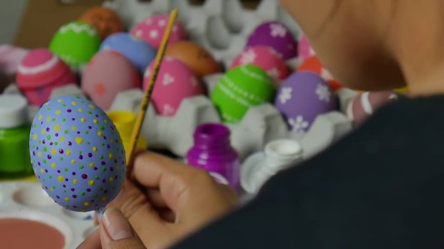 Beautiful art on eggs in easter festival. Woman paint on easter eggs.