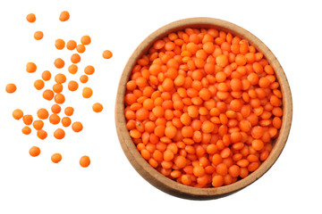 red lentils in wooden bowl isolated on white background. Top view.