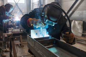 Welder performs welding work of metal structures