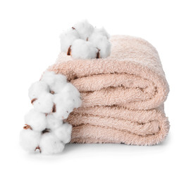Cotton flowers with soft towels on white background