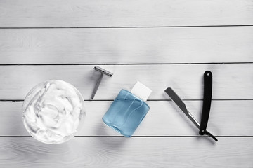 Set of male shaving accessories on white wooden background