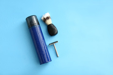 Set of male shaving accessories on color background