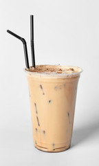 Cup of tasty frappe coffee on light background