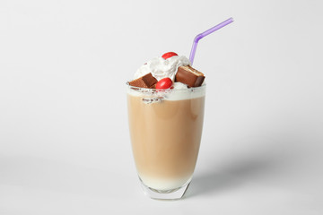 Glass of tasty frappe coffee on light background