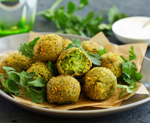 Fresh falafel balls on a dark background.