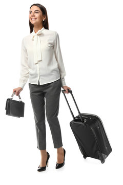 Young woman with luggage ready for business trip, on white background