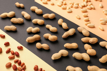 Tasty peanuts on color background