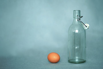 Empty bottle and chicken egg