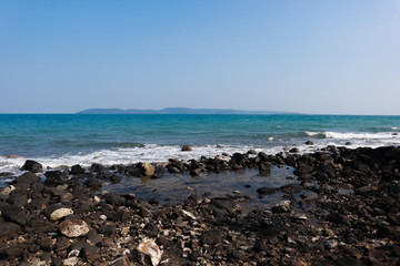 Fototapeta na wymiar Sea wave breaks on beach rocks landscape. Sea waves crash and splash on rocks. Beach rock sea wave breaking