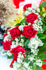 Valentines day background. Beautiful bouquet of roses on wooden table . Luxury bouquet made of red roses in flower shop Valentines Bouquet of red roses.  Rose bouquet. Soft focus of a Rose .