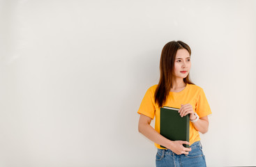 Asian college girls holding books separately on white