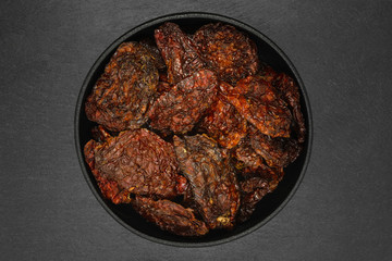 Sun dried tomatoes in cast iron bowl